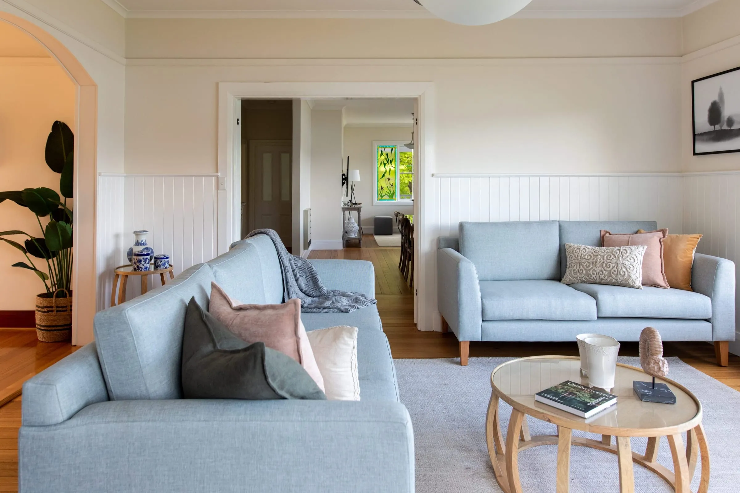 Sunlit living room with pale blue sofas